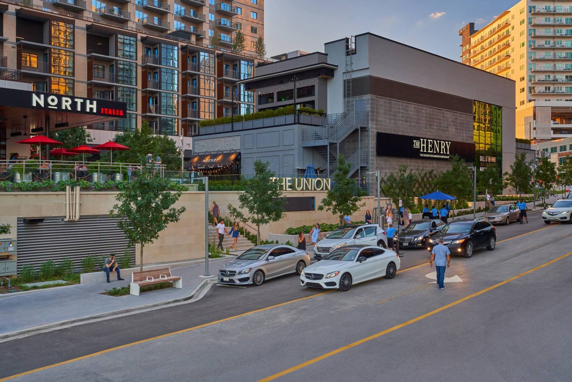 Street scene with buildings, cars, and pedestrians. Restaurants, 