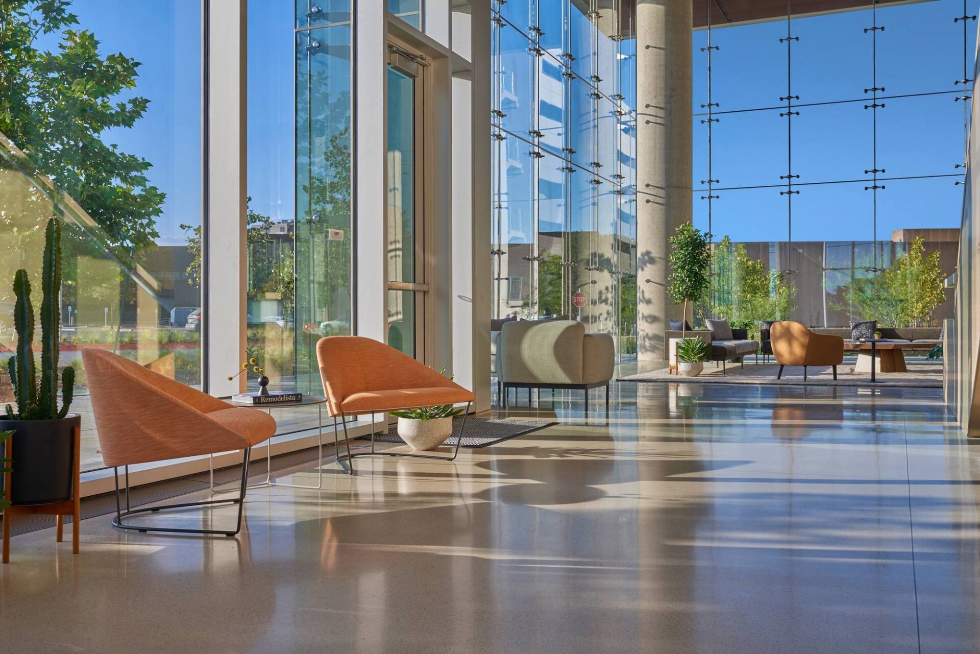 Bright, modern lobby with large windows, seating areas, and natural light.