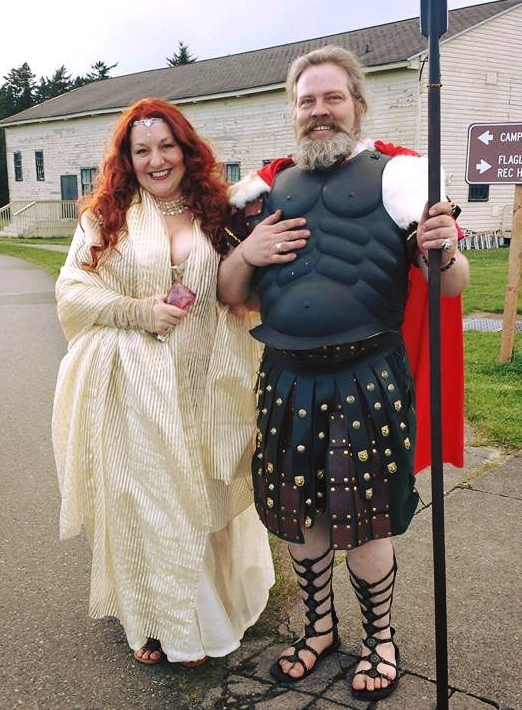 A man dressed as a roman soldier stands next to a woman in a white dress, representing Aphrodite.