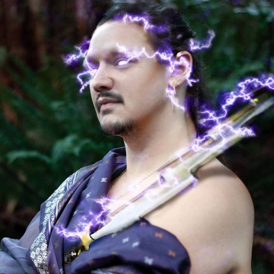 A man holding a lightning bolt and toga, representing Zeus.