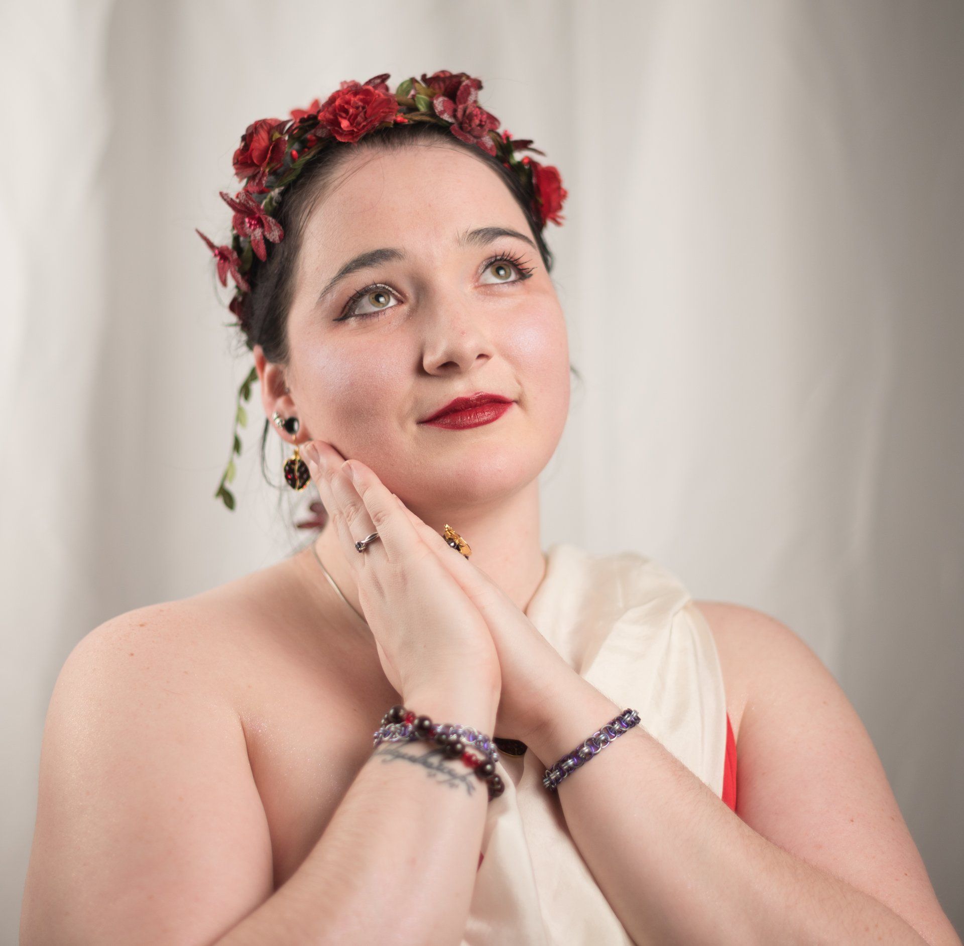 A woman wearing a flower crown on her head, representing Persephone.