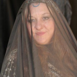 A woman wearing a veil with a crescent moon on her forehead, representing Hekate.