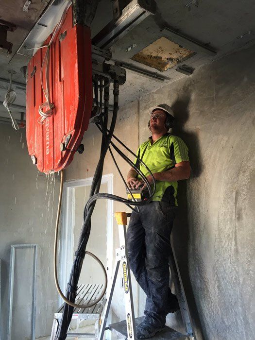 man sawing ceiling