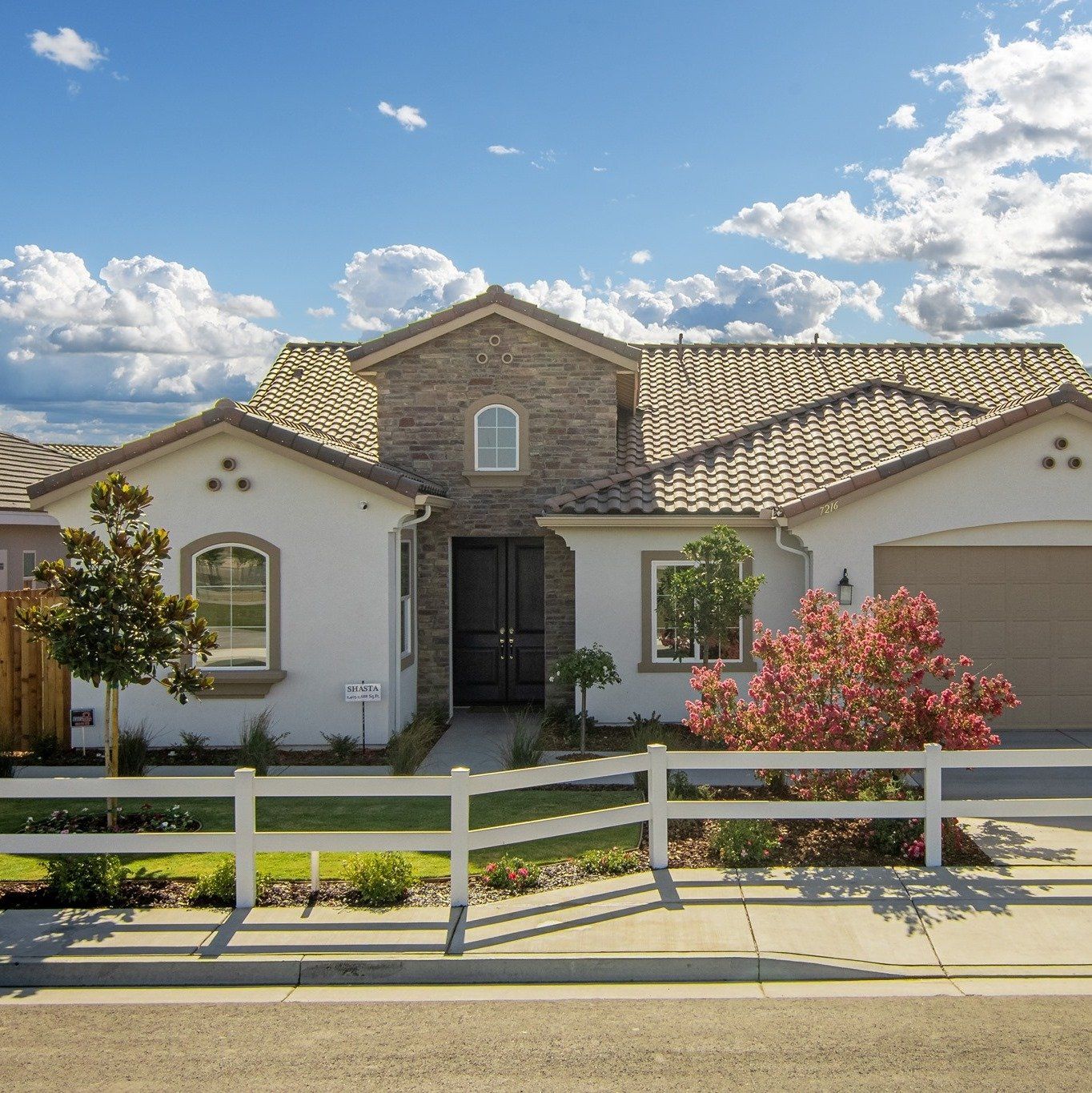 A house with a white fence in front of it