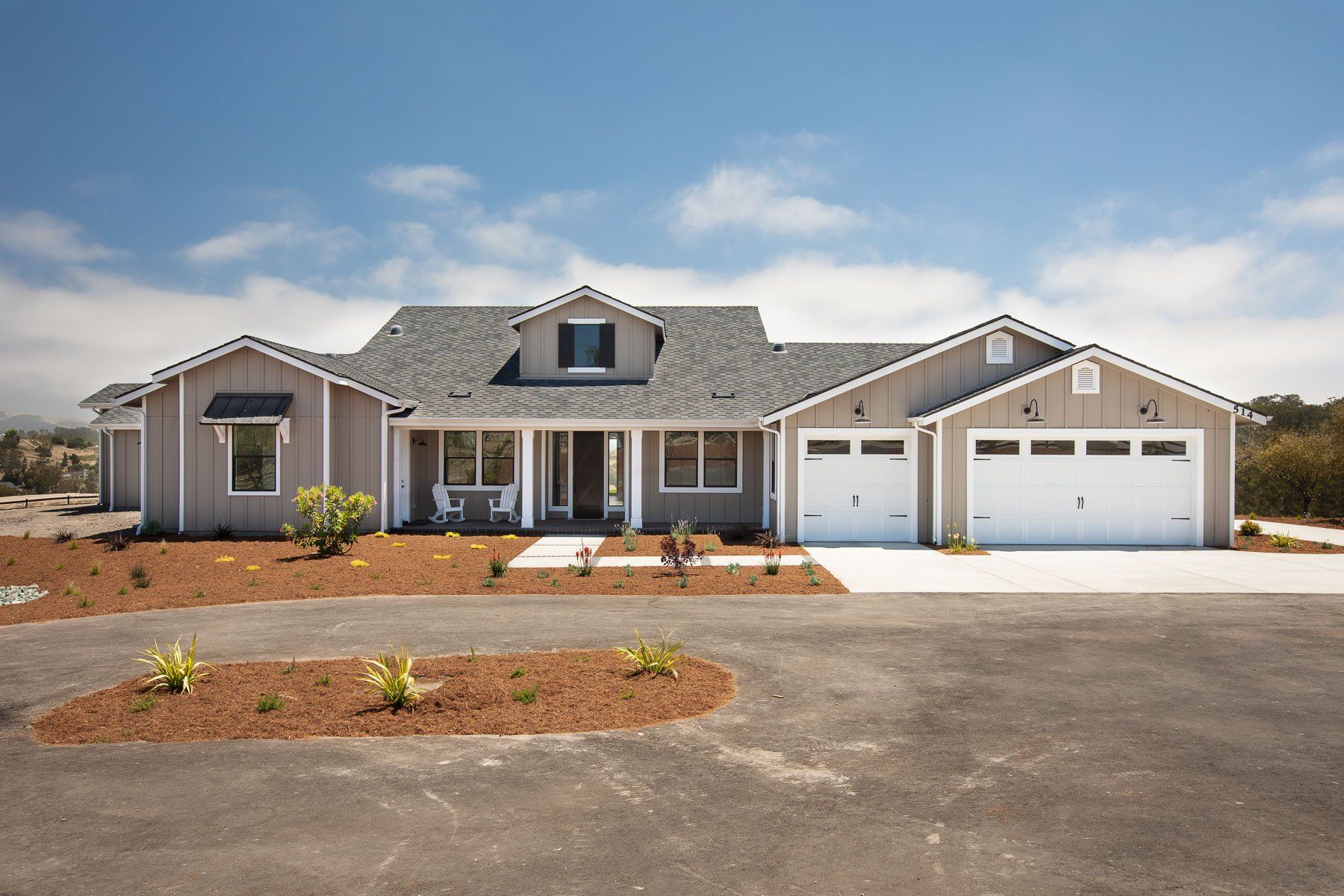 A large house with two garages and a porch