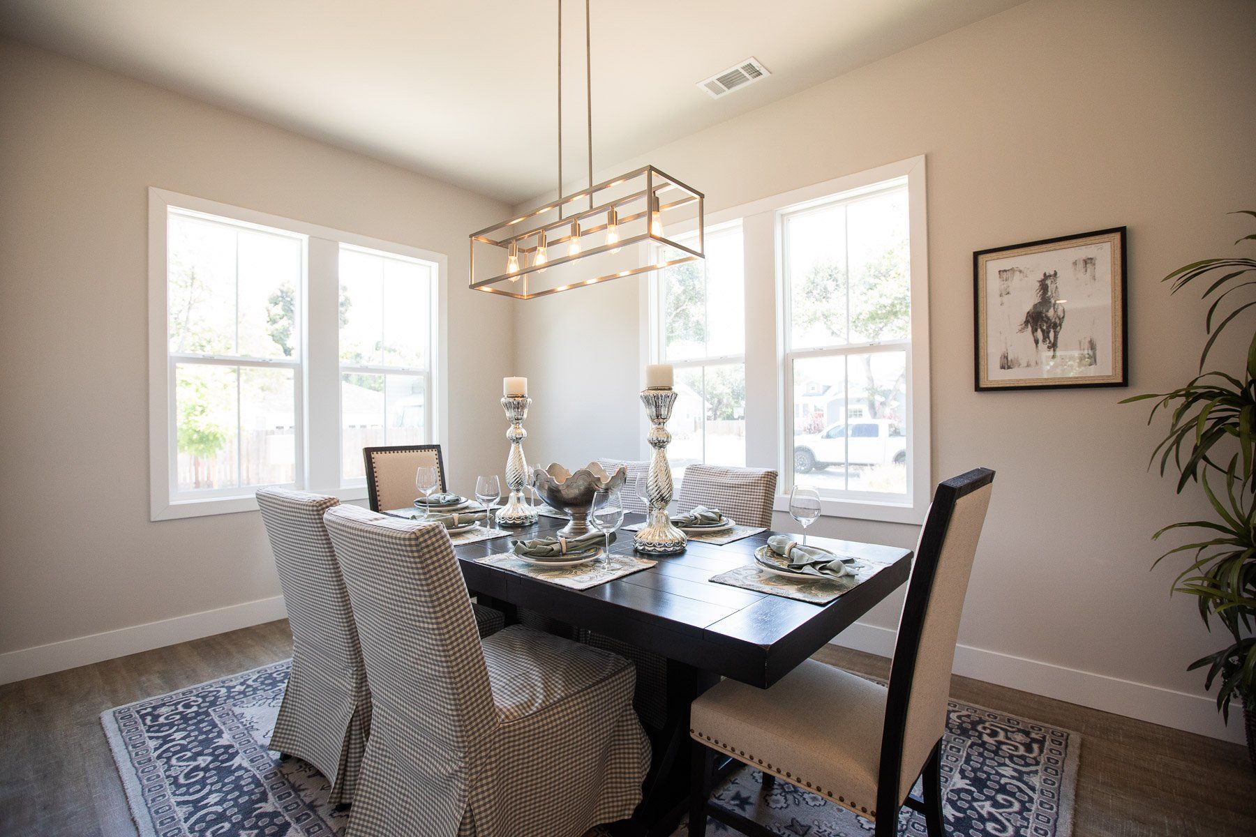 A dining room with a table and chairs and a chandelier.