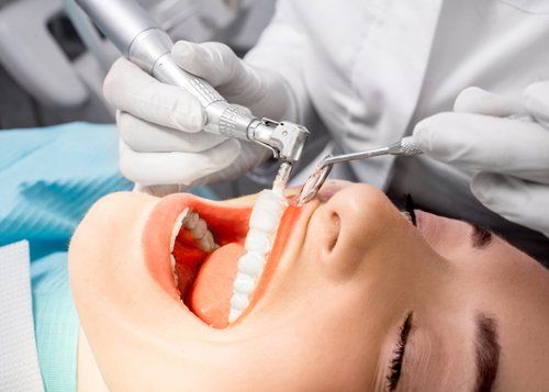 Dental Cleanings — Dentist Making Professional Teeth Cleaning to Young Patient in Jasper, IN Dental Cleanings — Dentist Making Professional Teeth Cleaning to Young Patient in Jasper, IN