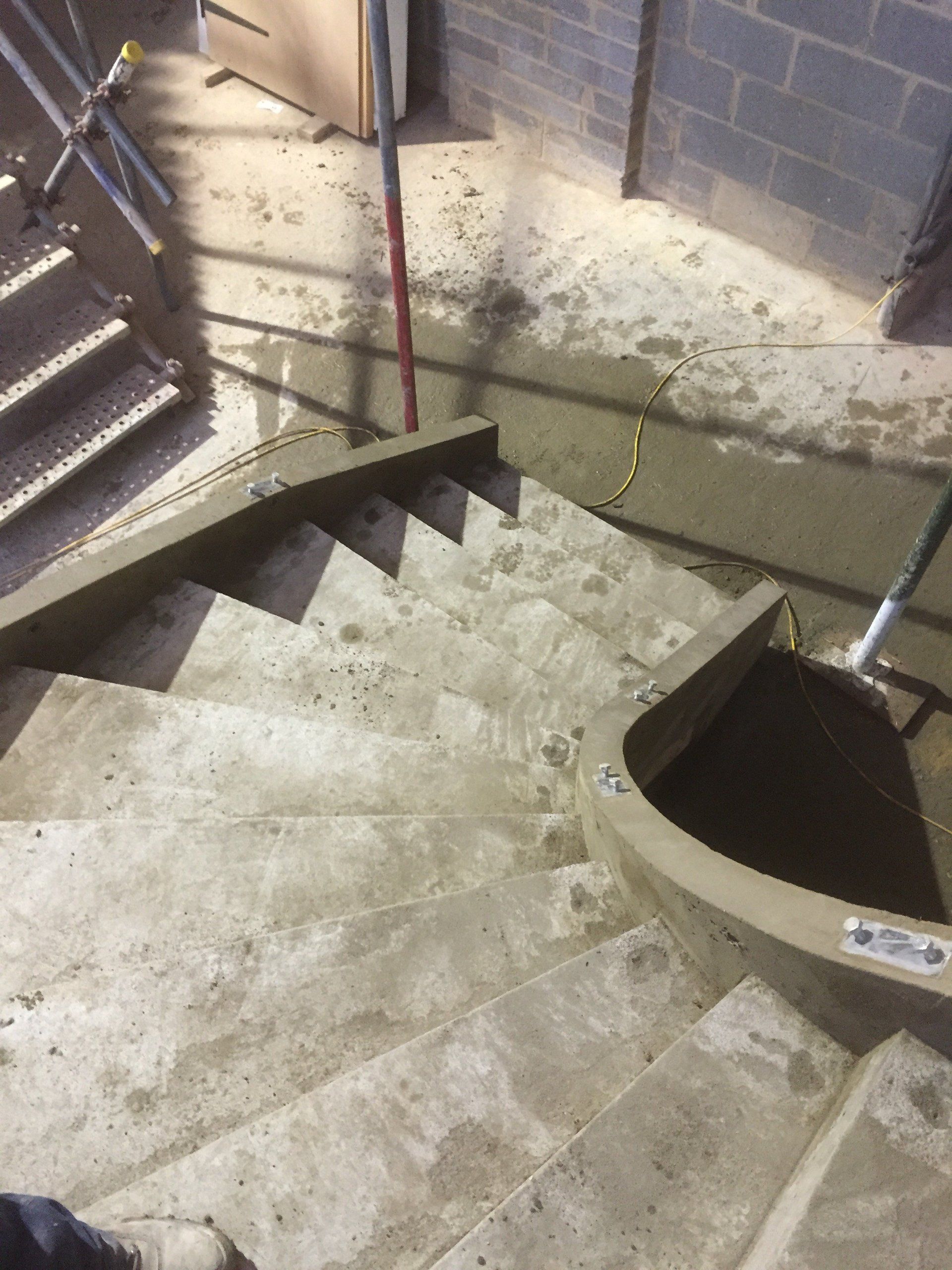 A person is standing on a set of concrete stairs.