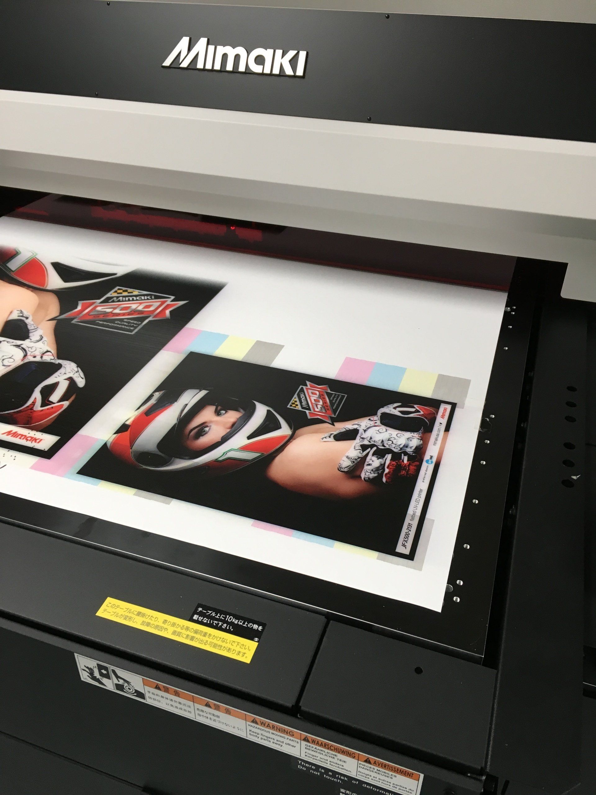 A mimaki printer is printing a picture of a woman