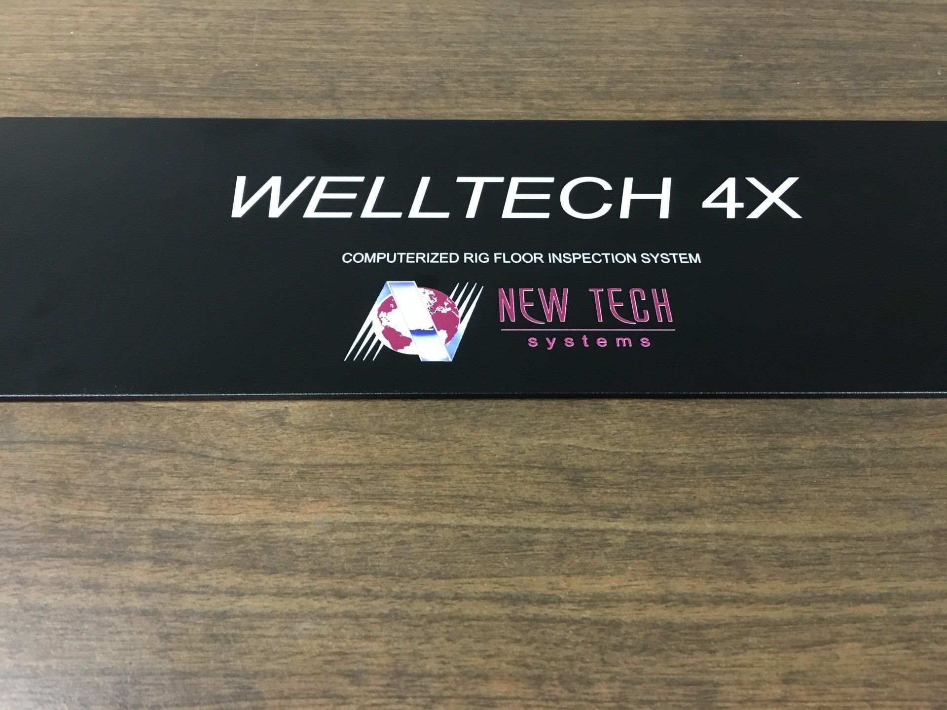 A black sign that says welltech 4x on it