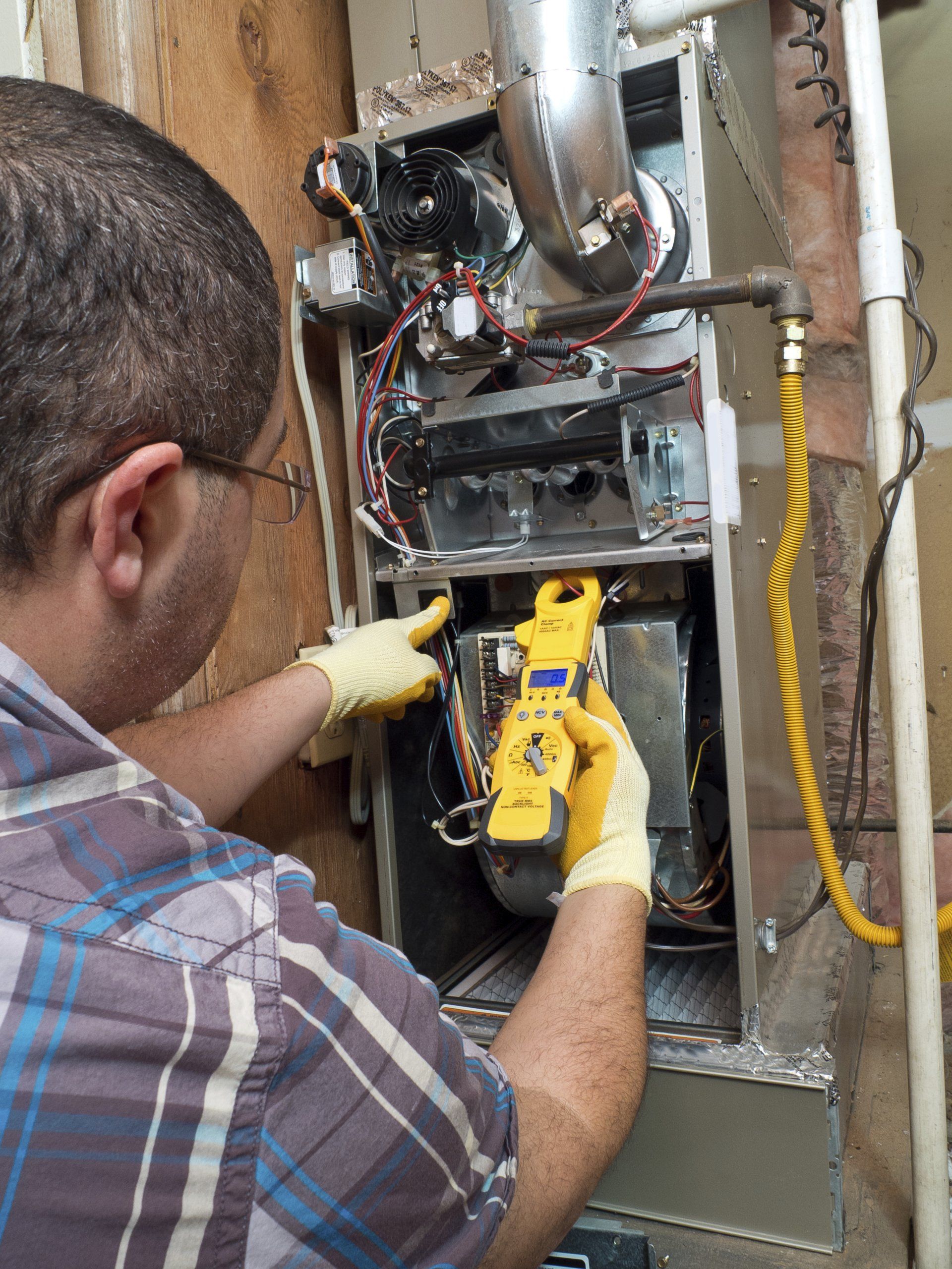 Furnace Repair — Repairman Conducting Furnace Repair in Spotsylvania, VA Furnace Repair — Repairman Conducting Furnace Repair in Spotsylvania, VA