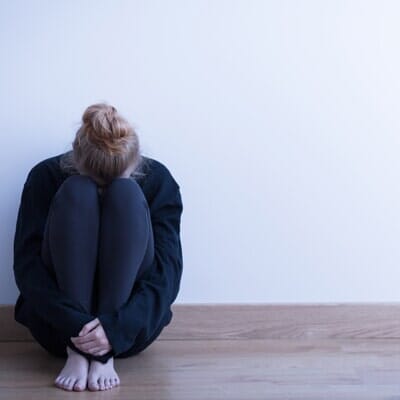 Woman curling up — counseling in Portland, OR