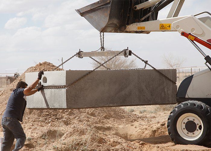Septic Tank Excavation Work — Man Installing Septic Tank With Excavation Truck In Harvest, AL