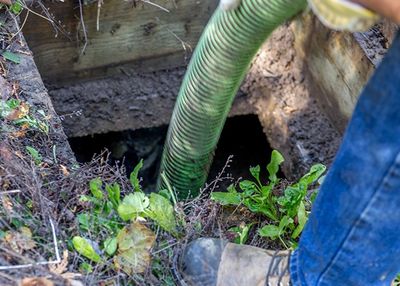 Septic Tank Pumping — Worker Emptying Septic In Harvest, AL Septic Tank Pumping — Worker Emptying Septic In Harvest, AL