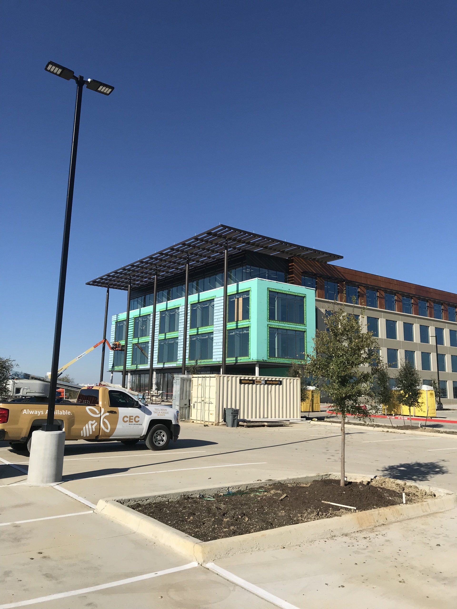 A truck is parked in front of a building under construction