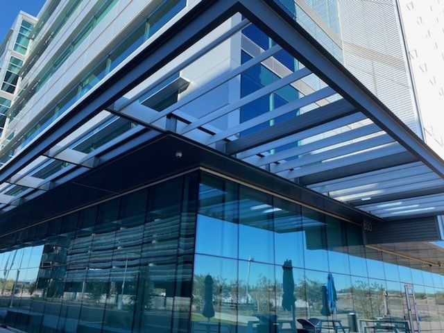A large glass building with a canopy over the entrance