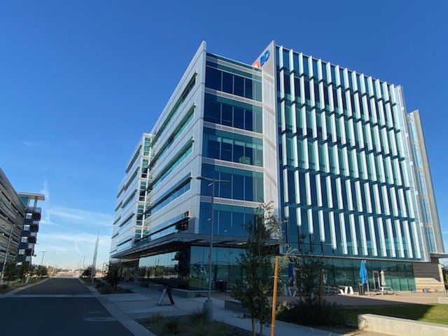 A large building with a blue sky in the background