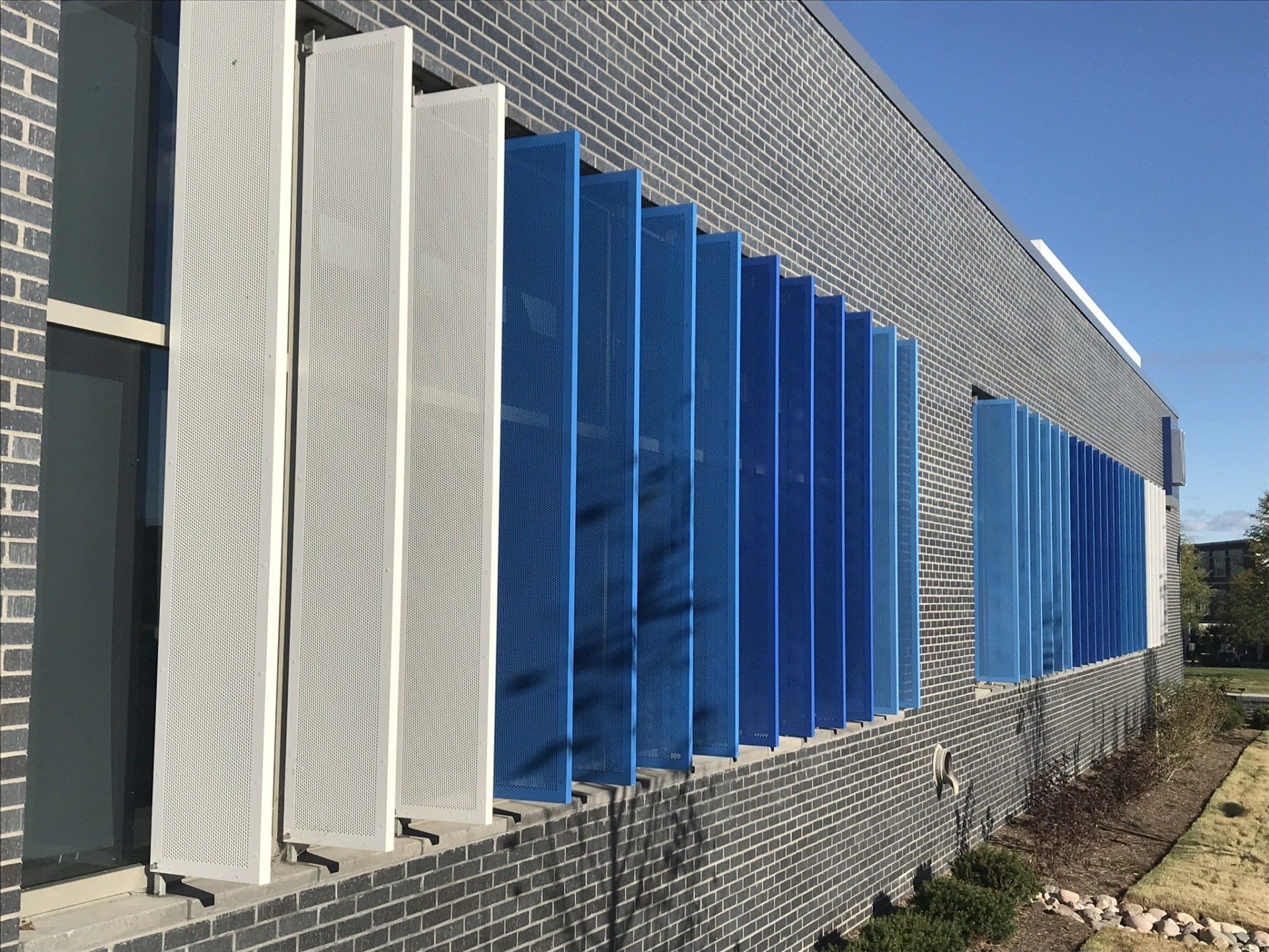 A building with blue and white shutters on the side of it