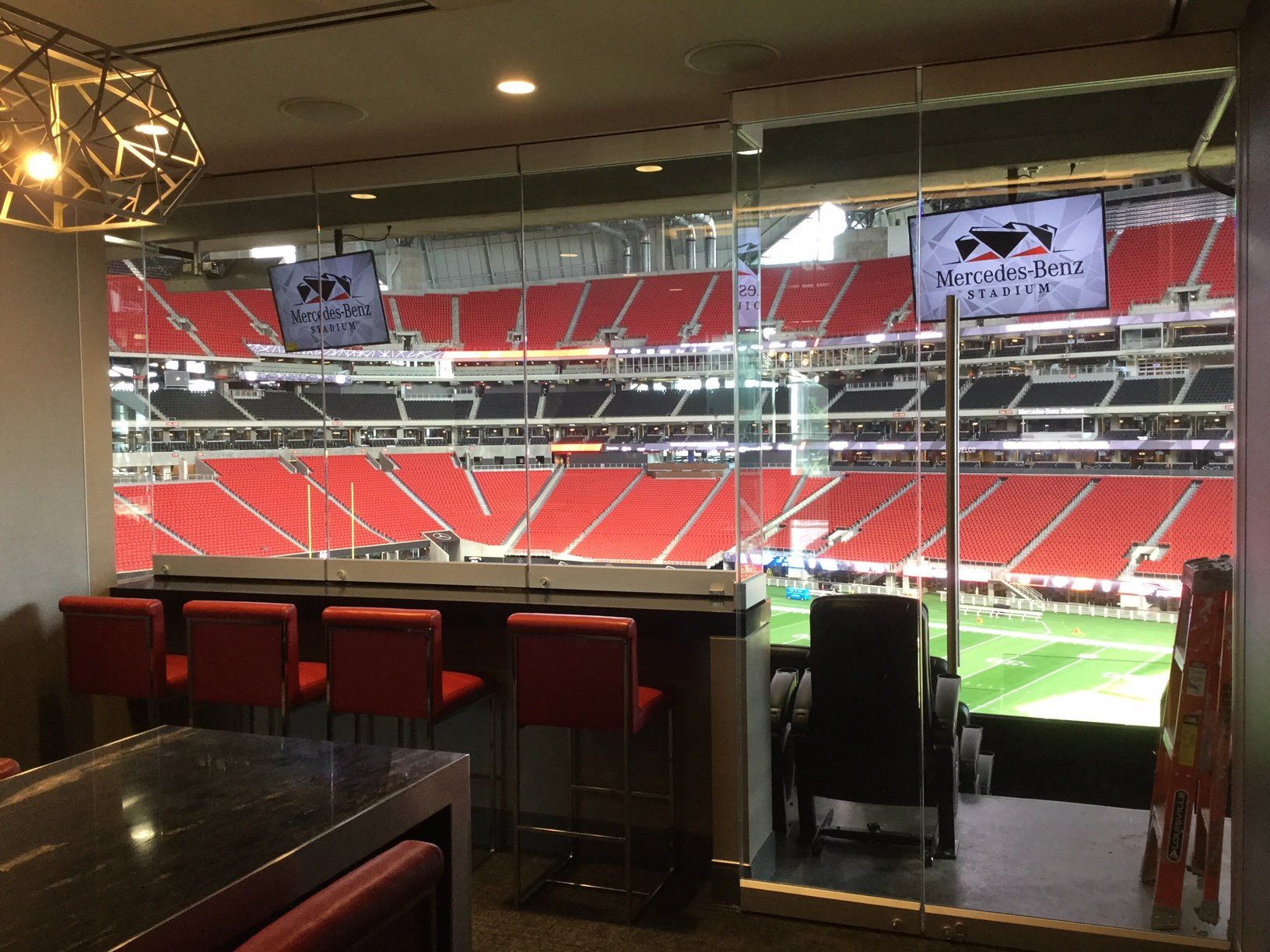 a room with a table and chairs in front of a stadium .