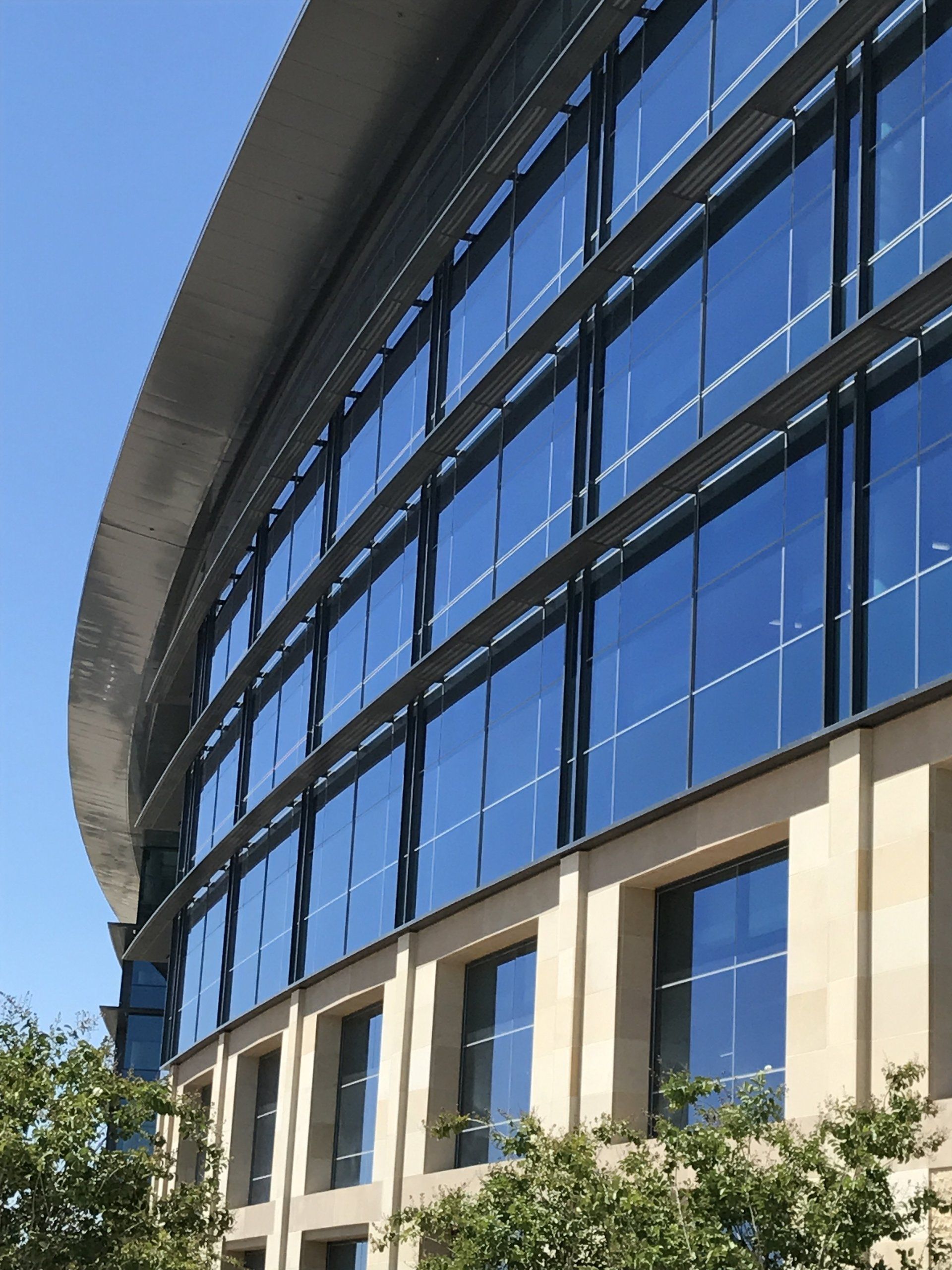 A large building with lots of windows and a curved roof