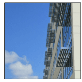 A building with fire escapes against a blue sky