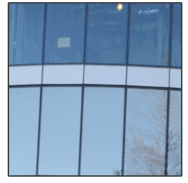 A building with a lot of windows and a blue sky in the background