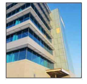 Looking up at a tall building with lots of windows
