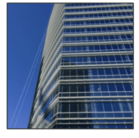Looking up at a tall building with a blue sky in the background