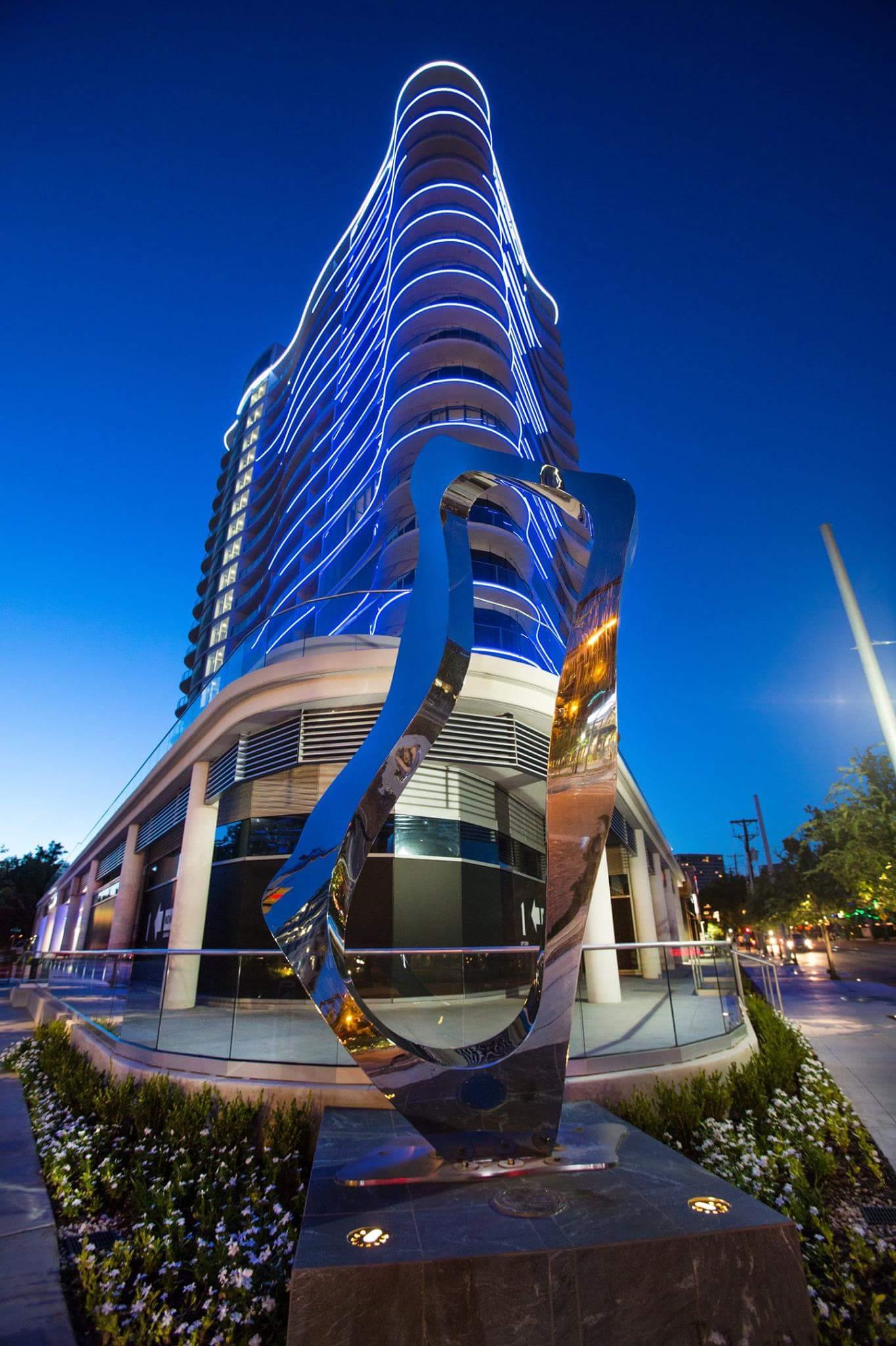 A large building with a sculpture in front of it