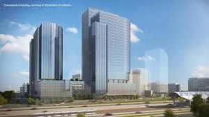 An artist 's impression of a large building in a city.