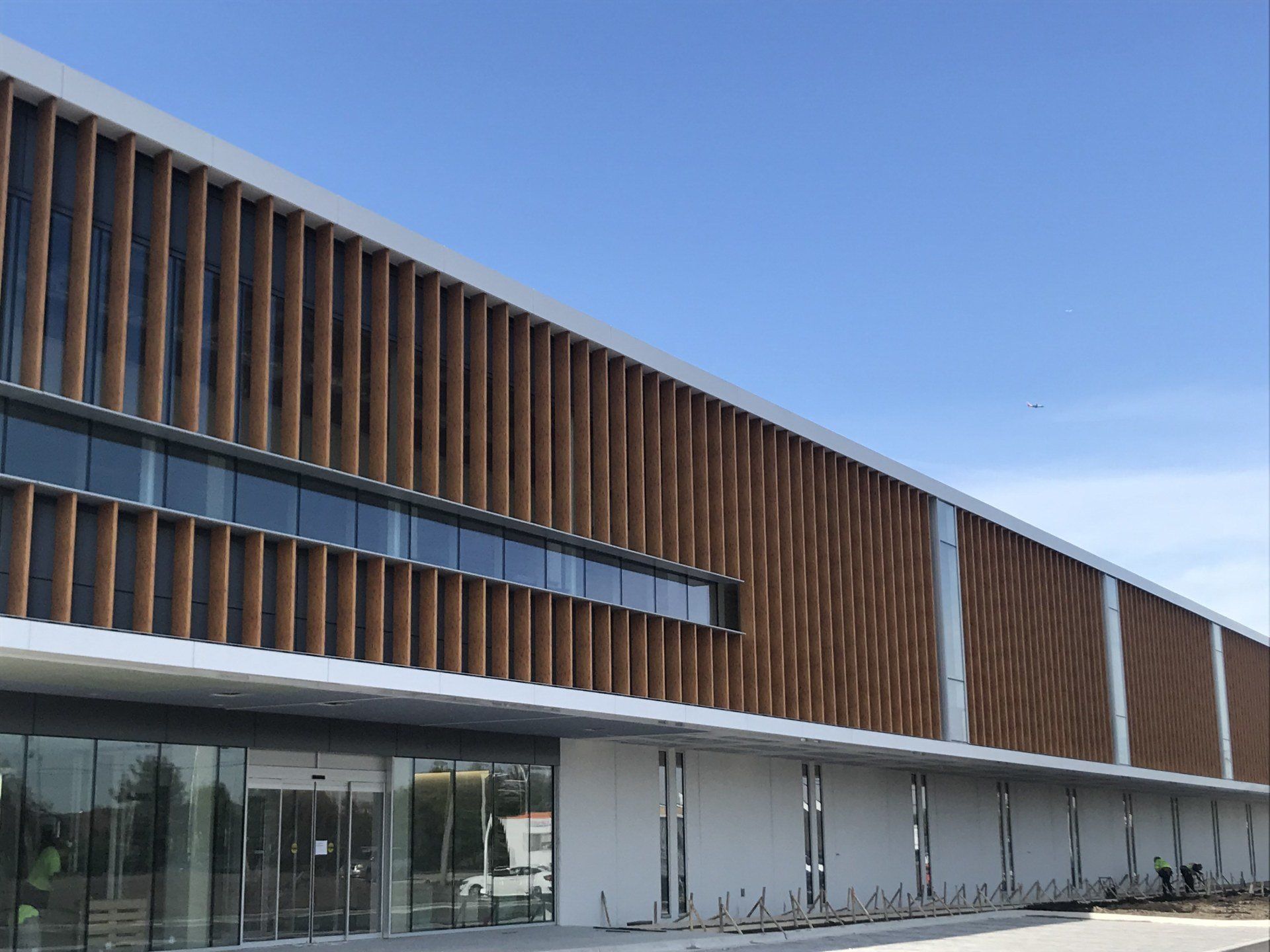 A large building with a lot of windows and a wooden facade