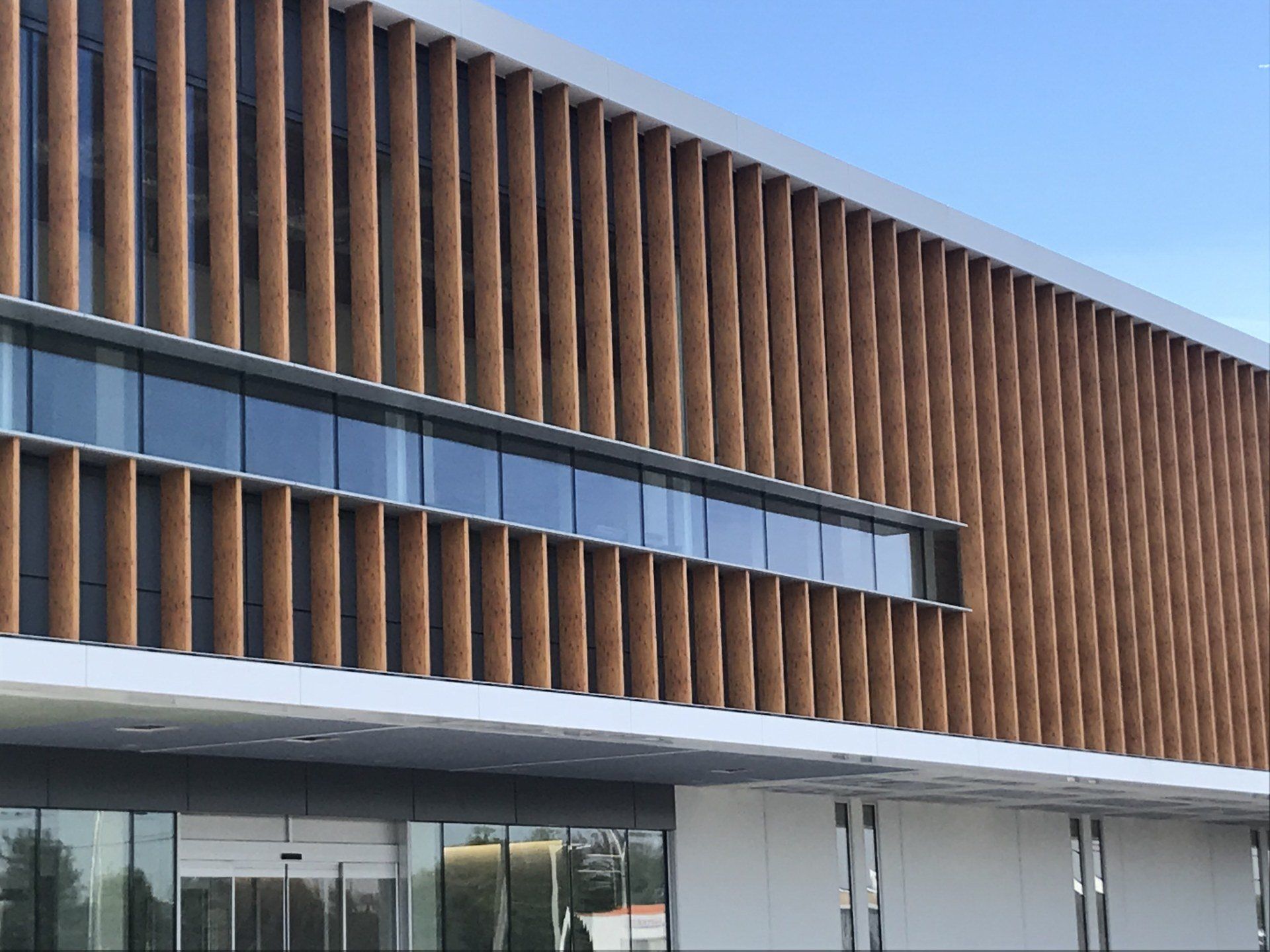 A large building with a lot of windows and a wooden facade