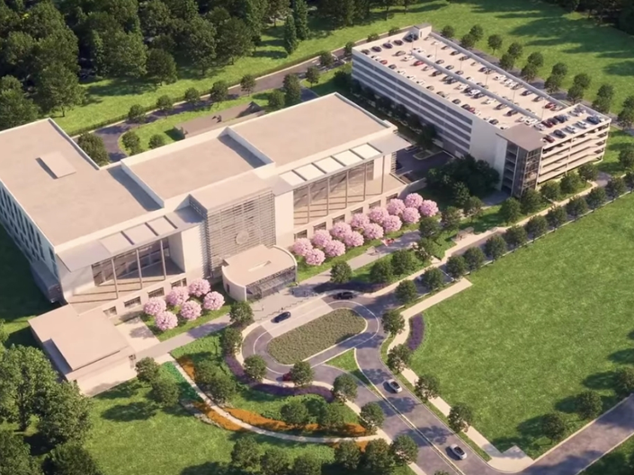 An aerial view of a large building surrounded by trees