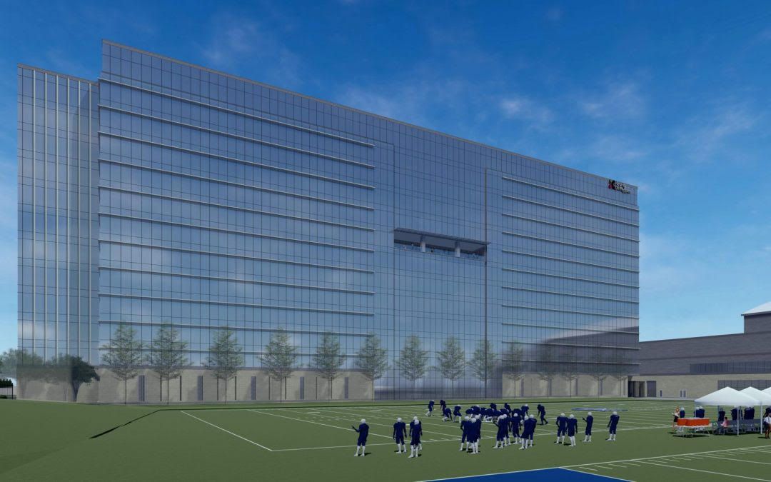 A group of people are standing in front of a large building.