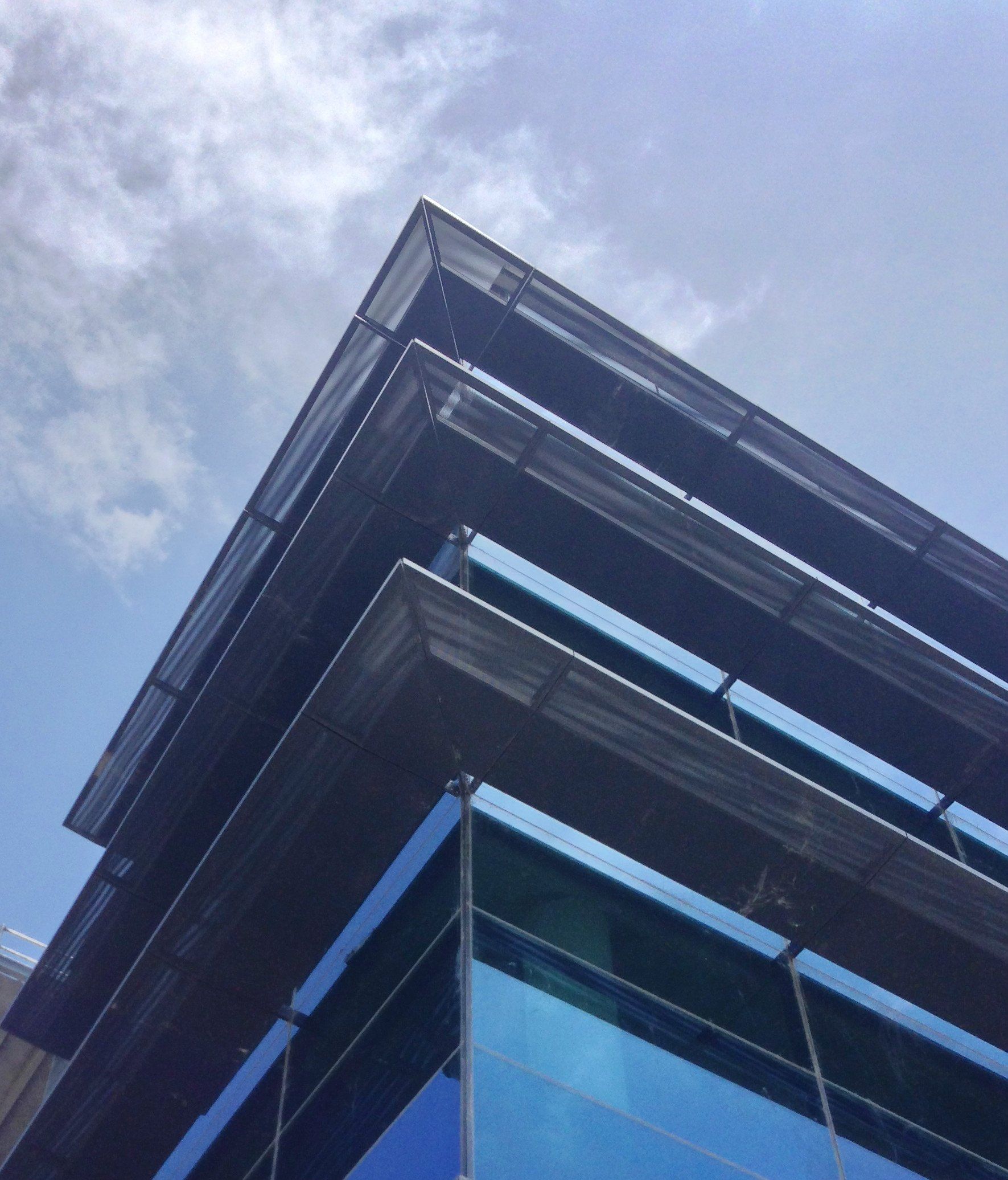 Looking up at a building with a blue sky in the background