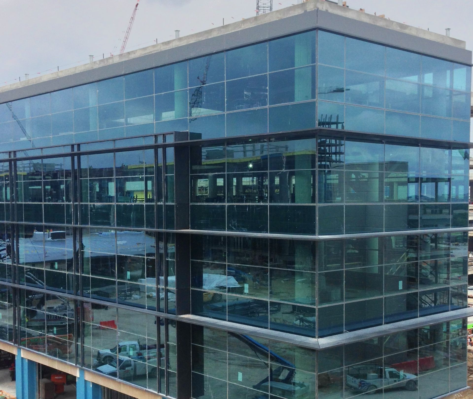 A large building with a lot of windows is under construction.