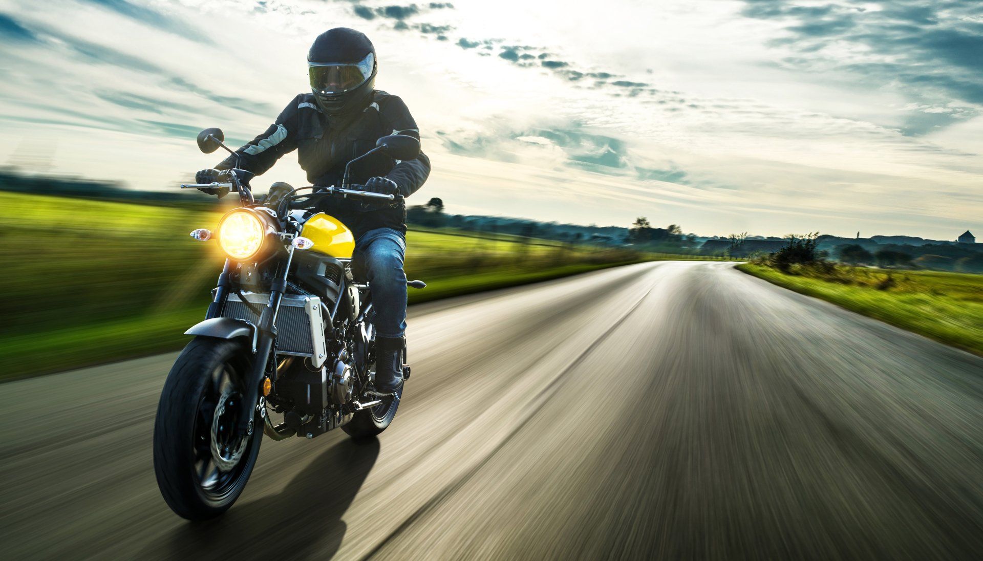 motorcycle driver at dusk image