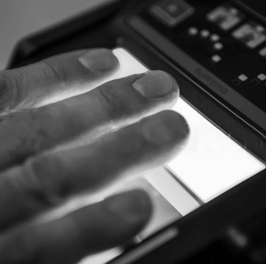 A black and white photo of a person pressing a button