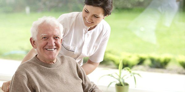 uralba hostel an elderly person in a chair held by a care taker uralba hostel an elderly person in a chair held by a care taker