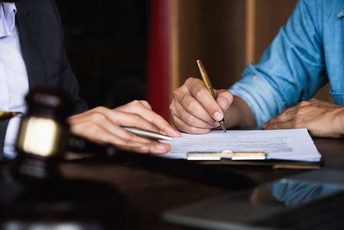 Lawyer and Client Signing Documents — Oak Harbor, OH — McKean & McKean Lawyer and Client Signing Documents — Oak Harbor, OH — McKean & McKean
