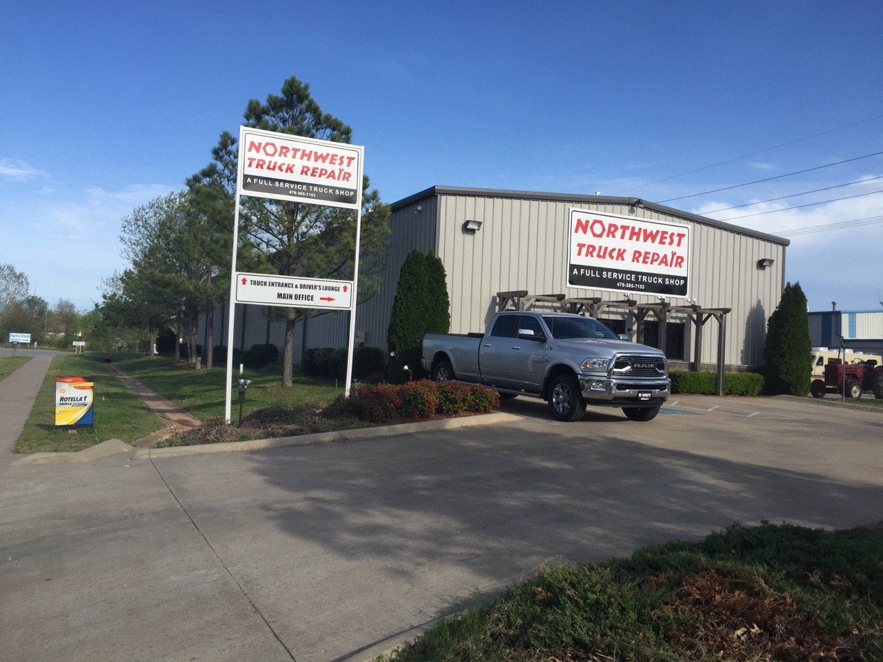 Northwest Train Repair building with a sign and a parked truck.