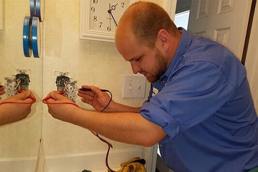 Electrician Measuring Voltage — Licensed Electricians in Merriam, KS Electrician Measuring Voltage — Licensed Electricians in Merriam, KS