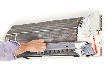 a man repairing an ac unit