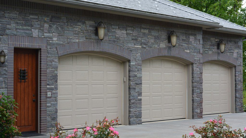 Three Garage Door With Wall Lamp — Central Square, NY — Bonnet Sales & Service, Inc.