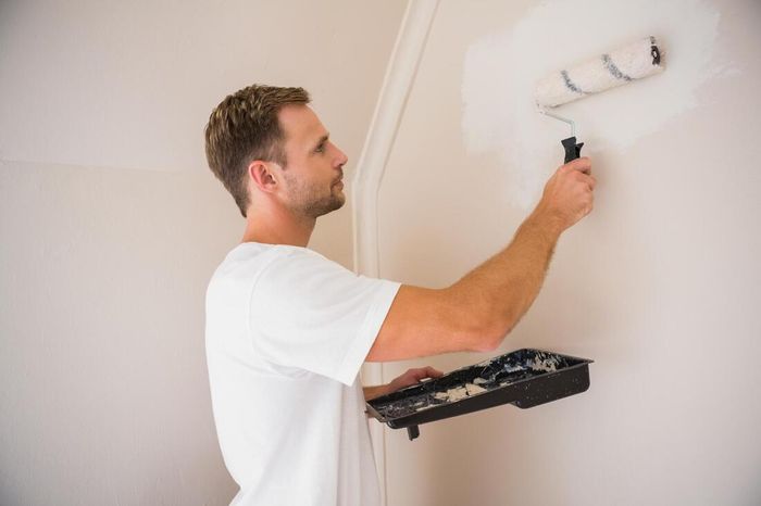 man painting drywall in Orange County