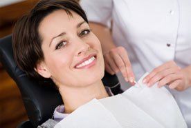 A dental nurse pinning a protective 