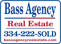 A bass agency real estate sign with a phone number