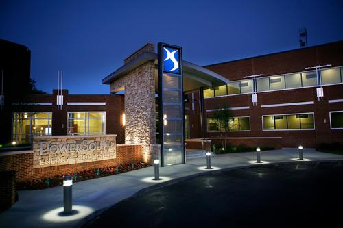 A large brick building with a blue x on it