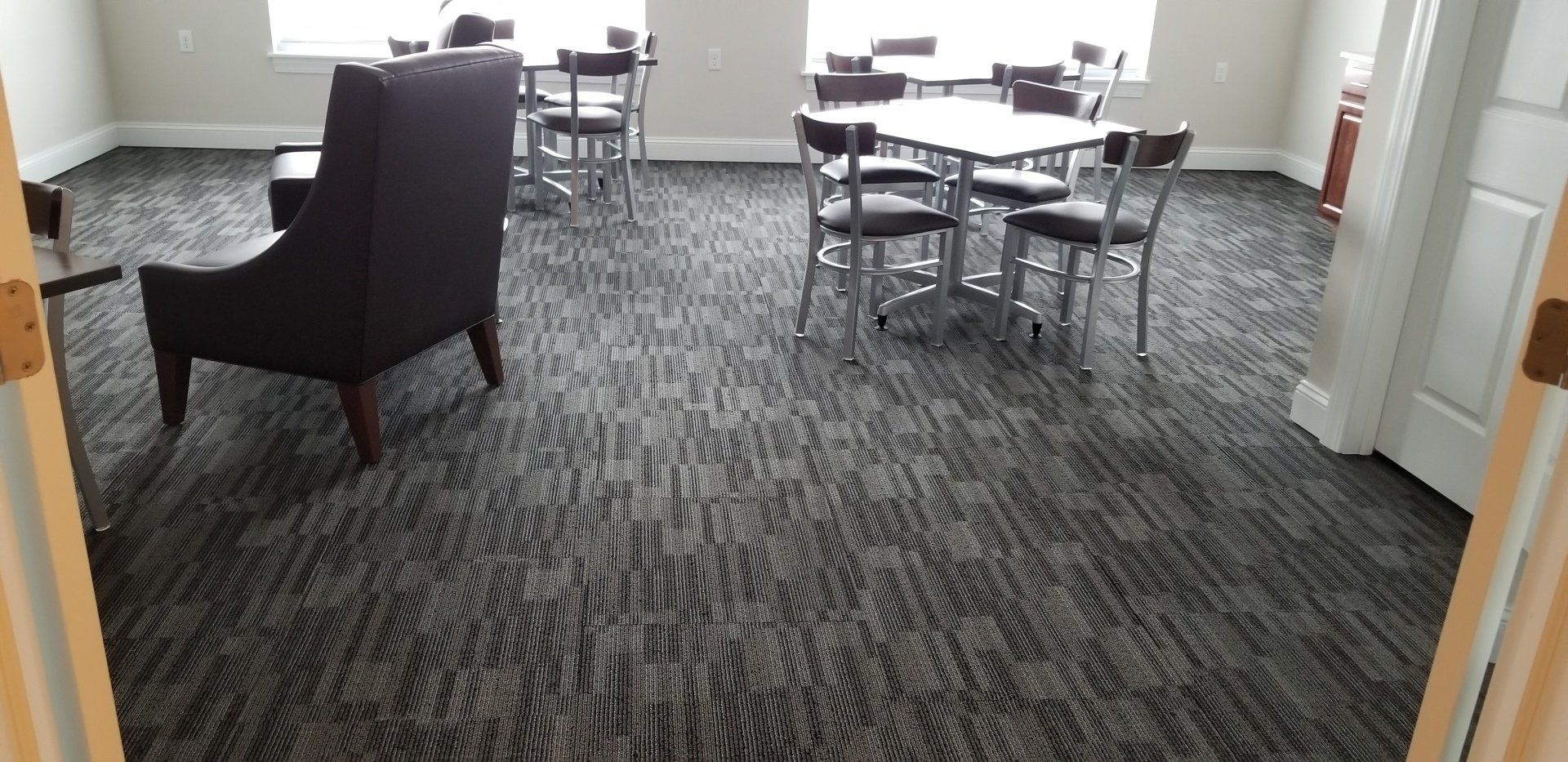 Floor Installation — Man Cutting Carpet With Cutter in Hamburg, NY Floor Installation — Man Cutting Carpet With Cutter in Hamburg, NY