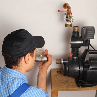 Man installing a water pump Man installing a water pump